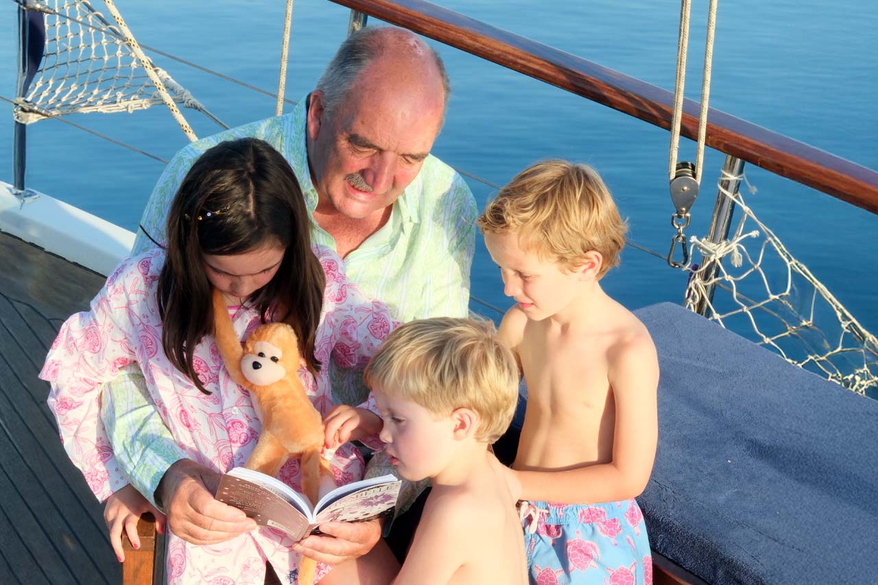 Grandfather_reading_to_Grandchildren_on_Deck